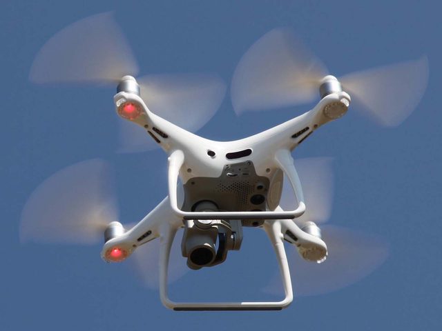 Drone in flight taking aerial images of an accident scene